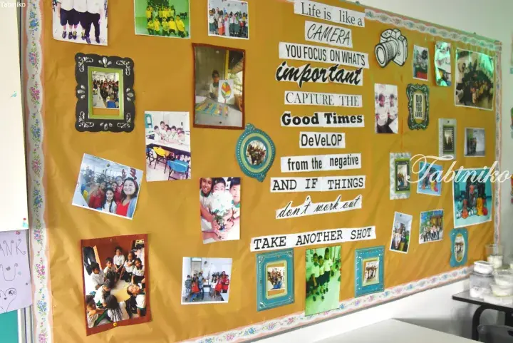 Classroom bulletin board with photos and inspirational quote about life being like a camera.