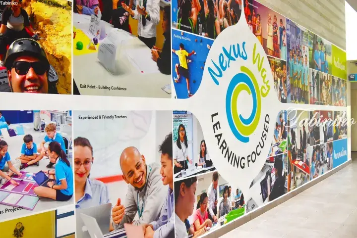 Nexus Way school wall display featuring student activities, teachers, and the ‘Learning Focused’ logo.