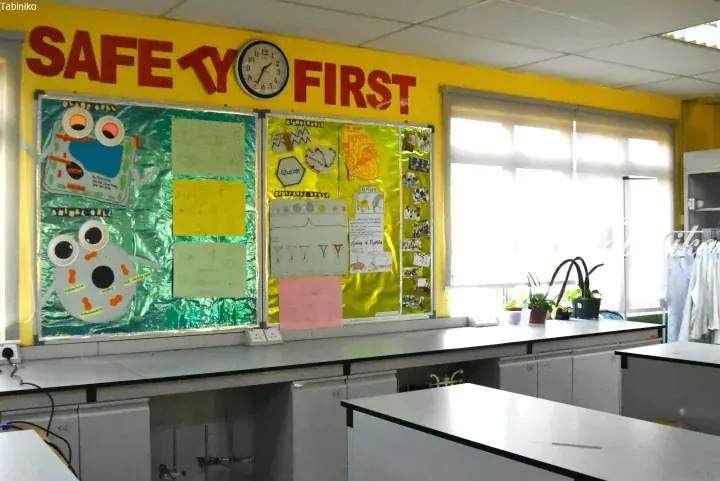 Science classroom with safety first sign, student cell models, and lab benches.
