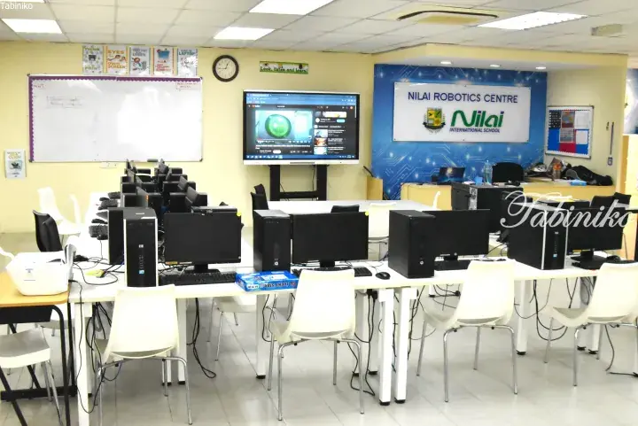 Nilai Robotics Centre classroom with computer workstations and a large screen at Nilai International School.