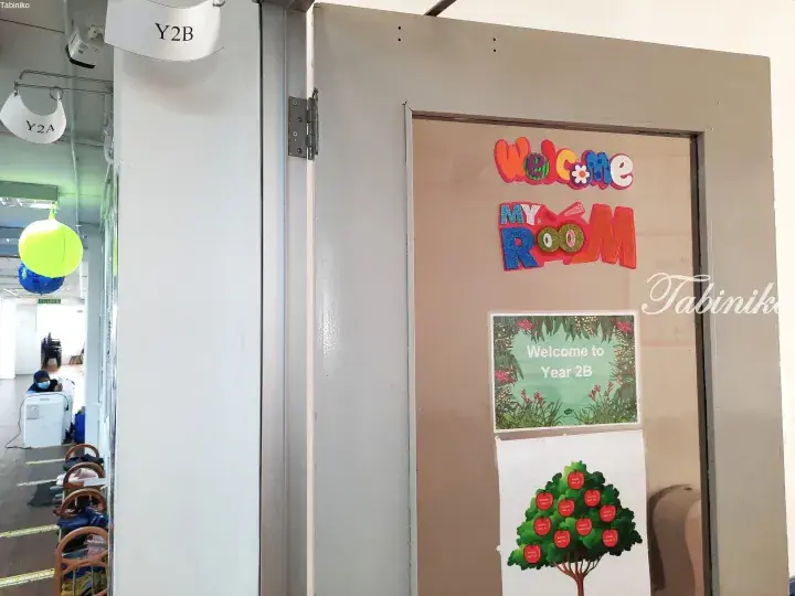 Classroom door labeled Y2B with a colorful Welcome sign and a poster showing the Year 2B class list on a tree.