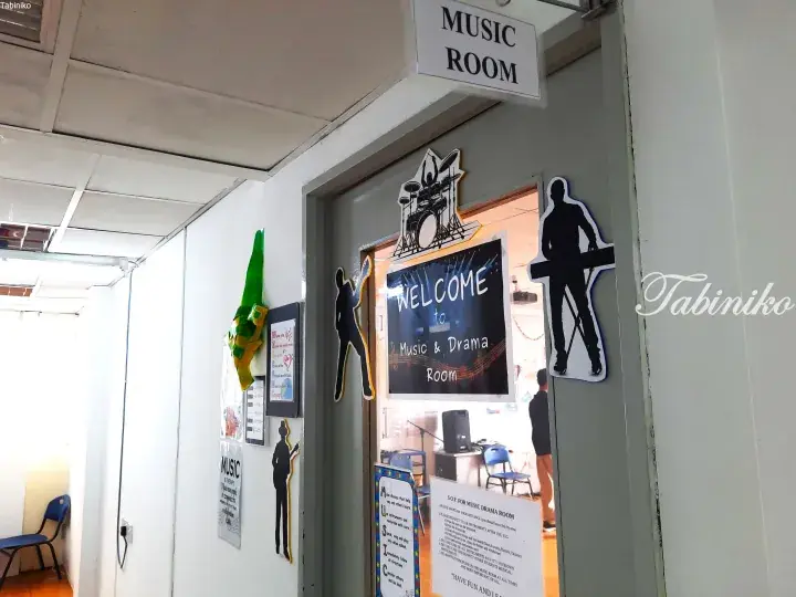 Entrance to a school music and drama room with musician silhouettes and a welcome sign.