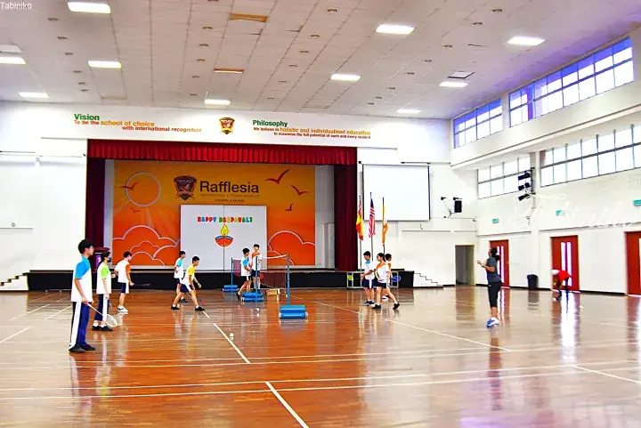 Students playing badminton in the hall of Rafflesia International School, Puchong, Malaysia.