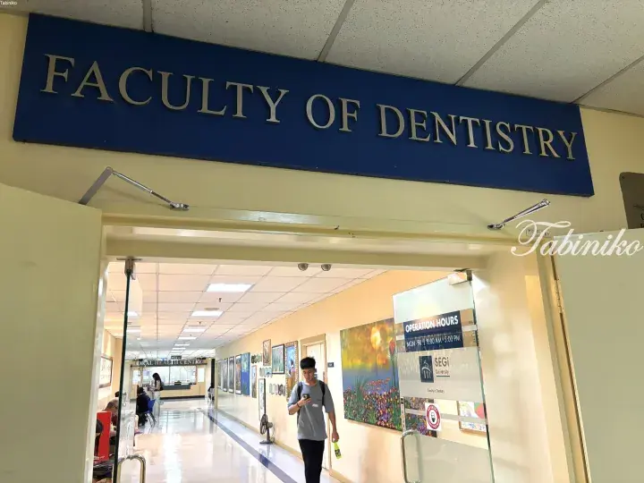 Entrance to the Faculty of Dentistry at SEGi University with a student walking through the hallway.