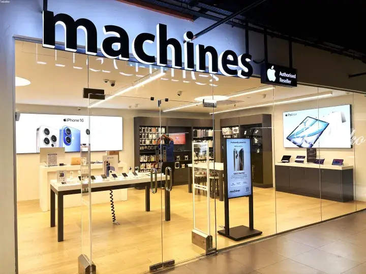 Machines Apple Authorised Reseller storefront displaying iPhone 16 and iPad Air in a modern retail setting.