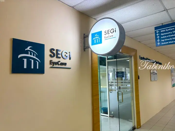 SEGi EyeCare clinic entrance with illuminated sign and directional signage for the Faculty of Optometry and Vision Sciences.