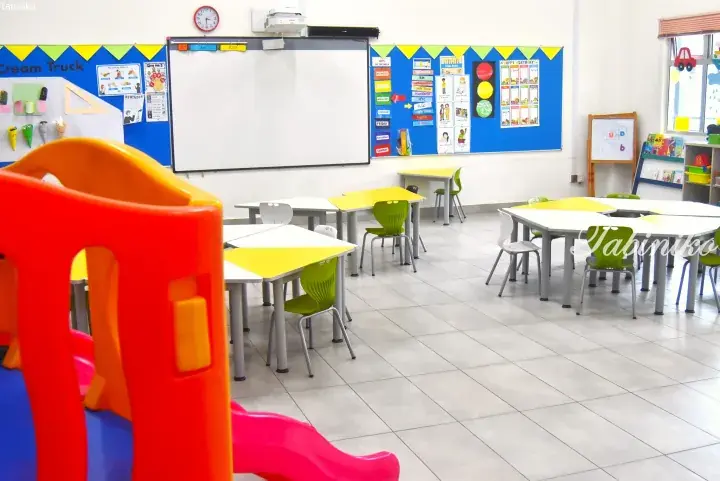 Bright classroom with colorful tables, chairs, and educational displays at a Malaysia preschool.
