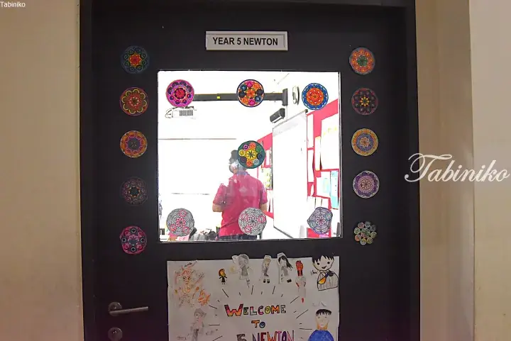 Decorated classroom door labeled Year 5 Newton with colorful mandala stickers and a student welcome poster.