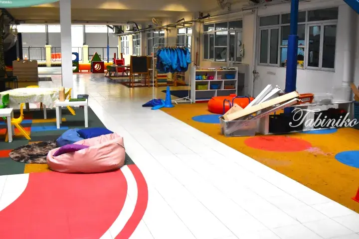 Colorful indoor play area with bean bags, toys, and activity zones in a modern Malaysian childcare center.