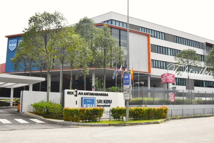 Sri KDU International School building exterior with entrance sign and flags in Malaysia.