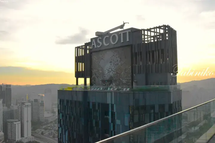 Ascott building rooftop with large phoenix mural and city skyline view at sunset in Kuala Lumpur