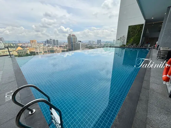 Infinity pool with city skyline view at a high-rise building in Malaysia.