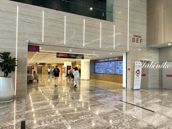 Modern lobby entrance to Towers D, E, and F at Sunway Medical Centre featuring polished floors and a digital consultant directory.