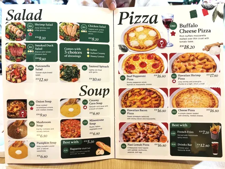 Menu showing salad, soup, and pizza options with prices in Malaysian Ringgit at a Malaysian restaurant.