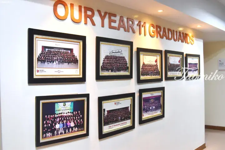 Wall display of framed Year 11 graduation photos at Taylor’s International School Kuala Lumpur.