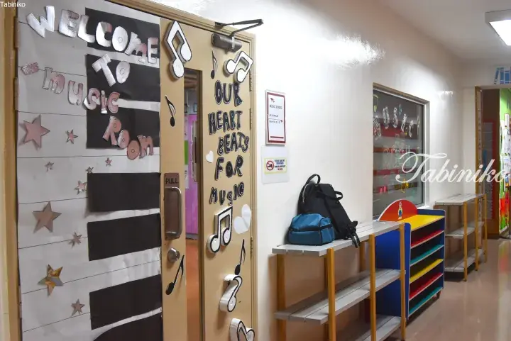 Decorated music room door with musical notes and a sign reading ‘Welcome to the Music Room’ in a school hallway.