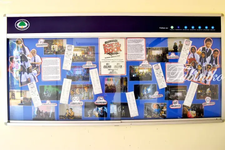 Bulletin board at Tenby Schools Malaysia showcasing the 2019 School of Rock musical production with student photos and event details.
