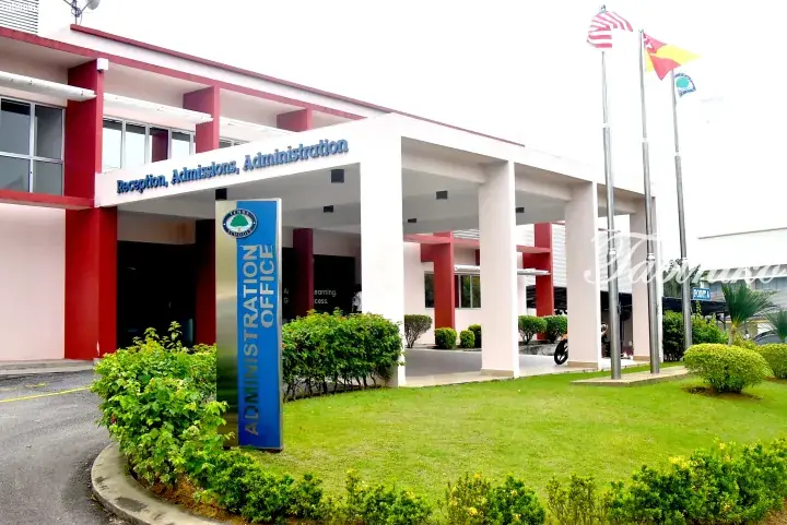 Tenby Schools administration building with reception, flags, and landscaped entrance.