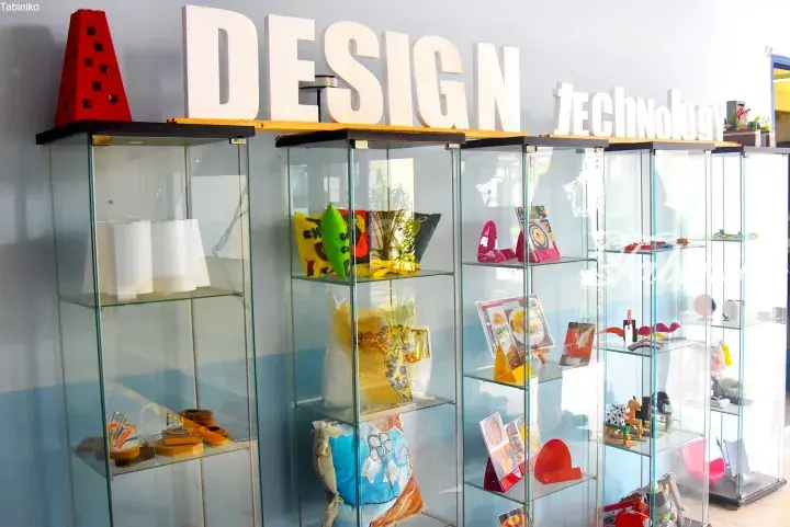 Glass display cabinets showcasing design and technology products under a large &ldquo;DESIGN technology&rdquo; sign.