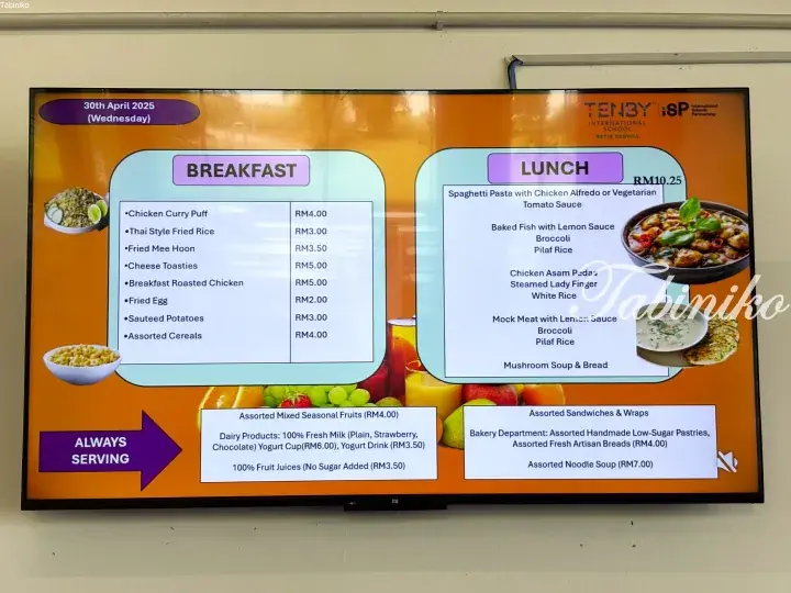 Digital menu board at Tenby International School Setia Ecohill showing breakfast and lunch options with prices for April 30, 2025.
