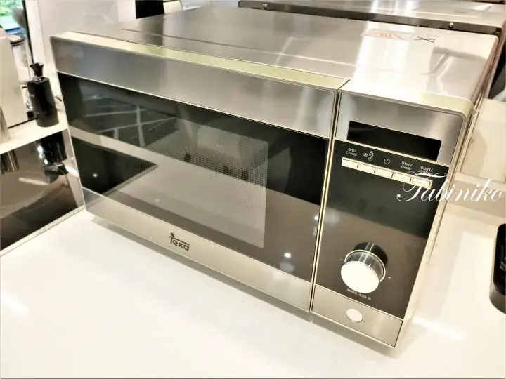 Stainless steel Teka microwave oven with digital display and control panel on a kitchen countertop