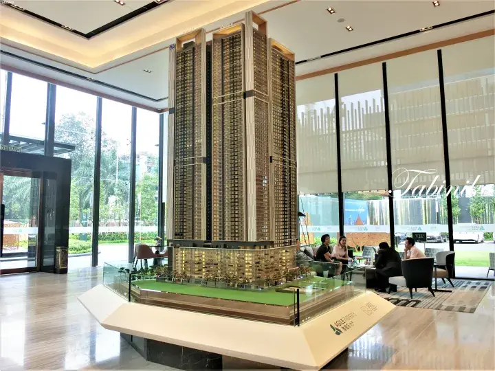 Architectural model of a high-rise condominium development in a modern sales gallery.