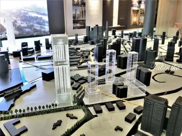 Architectural model of a modern city development featuring a tall skyscraper and Conlay Station.