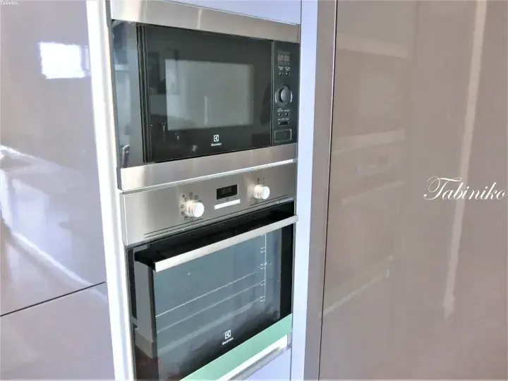Built-in Electrolux microwave and oven with stainless steel finish in a modern kitchen cabinet.