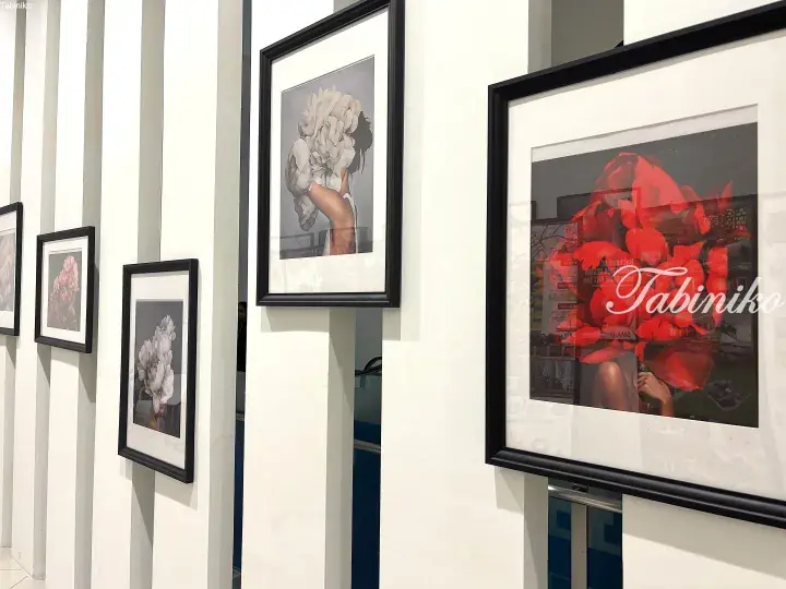 Framed floral art prints displayed on white walls in a modern gallery space.
