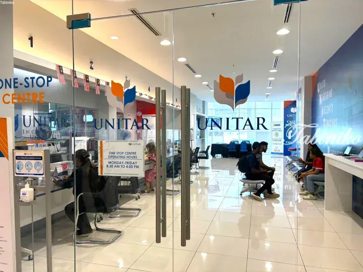 UNITAR International University’s One-Stop Centre reception area with students waiting and service counters.