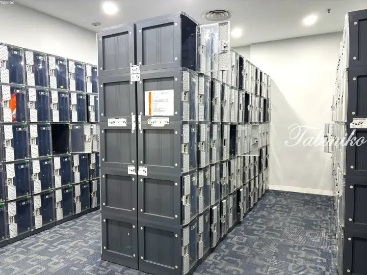 Rows of grey lockers with transparent doors in a modern facility, likely at UNITAR International University.