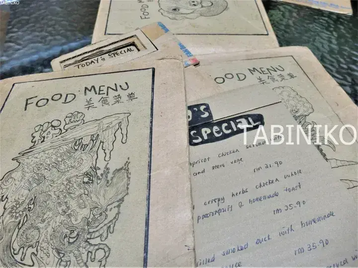 Hand-drawn cardboard food menu with Chinese characters and today&rsquo;s special dishes listed in RM.