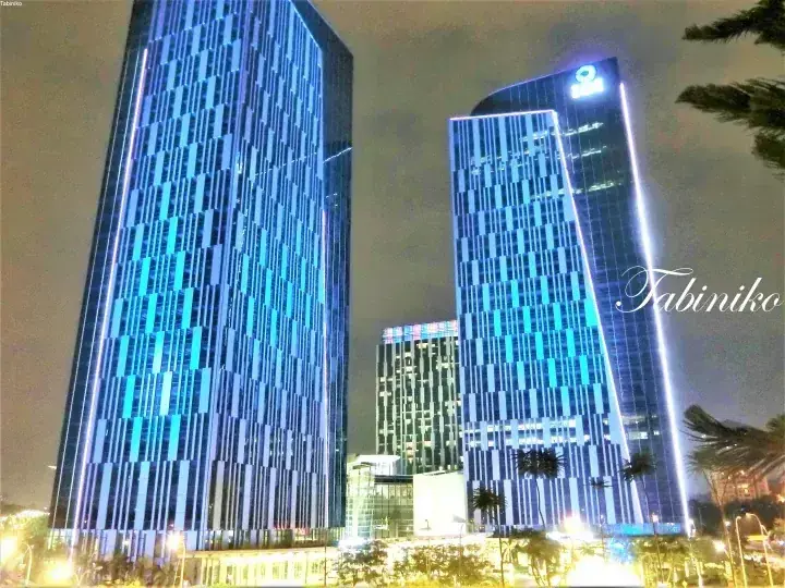 IOI City Mall towers illuminated in blue at night, showcasing modern architecture in Putrajaya.