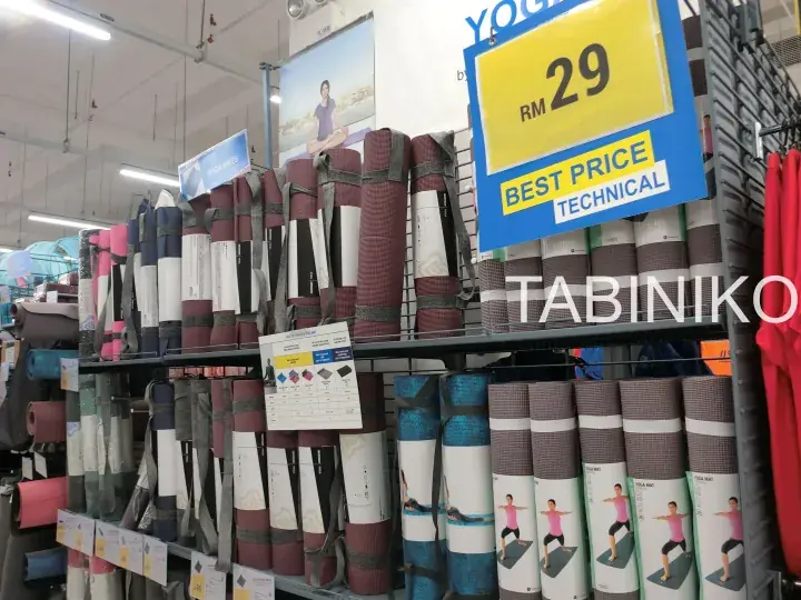 Shelves of rolled yoga mats in various colors with a yellow price tag showing RM 29 Best Price Technical in a store.