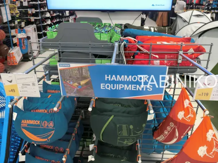Display of hammock equipments and bags at a Decathlon store with price tags visible.