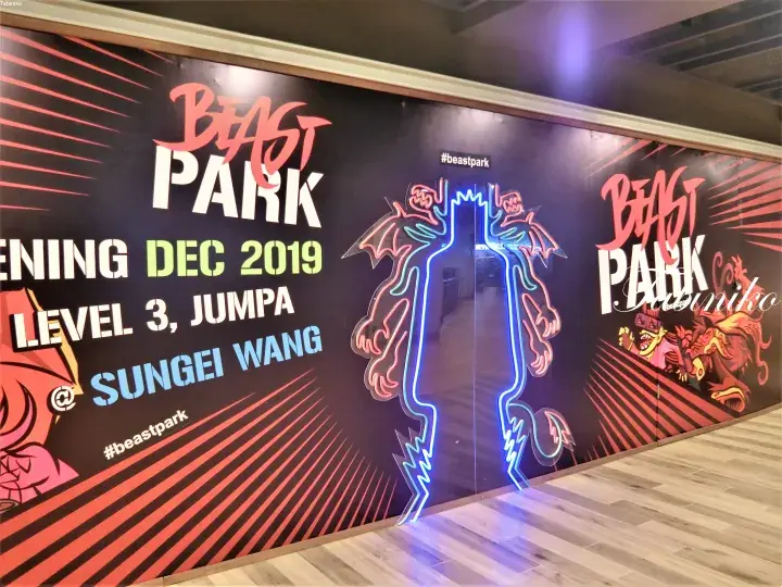 Beast Park promotional wall at Sungei Wang featuring neon dragon art and opening details for December 2019.