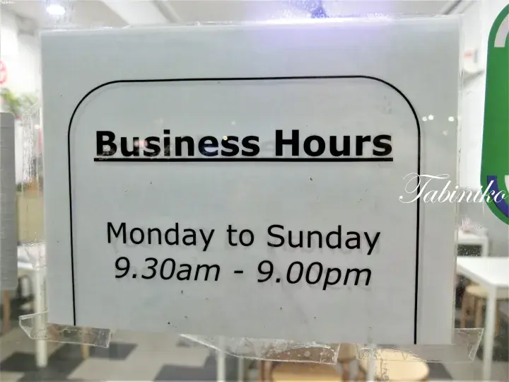 Business hours sign showing Monday to Sunday 9.30am to 9.00pm at a Malaysia establishment.