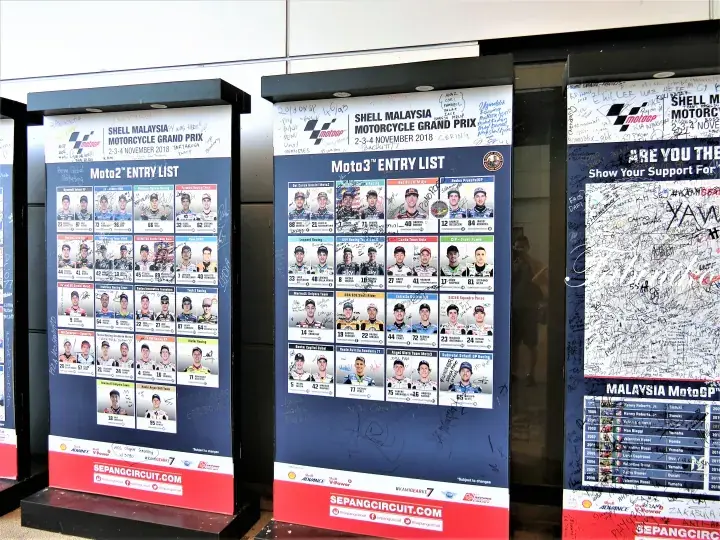 Entry list posters for the Shell Malaysia Motorcycle Grand Prix at Sepang Circuit, displaying Moto2 and Moto3 rider photos.