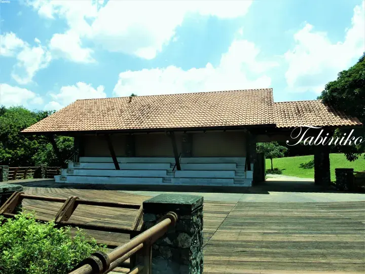 Traditional Malay-style building with tiled roof and white steps at Tabiniko resort under blue sky