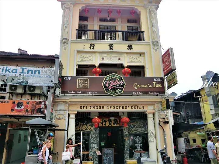 Selangor Crocers Guild building housing Oldies Cafe Bar and Grocer’s Inn in Chinatown, featuring colonial architecture and red lanterns.