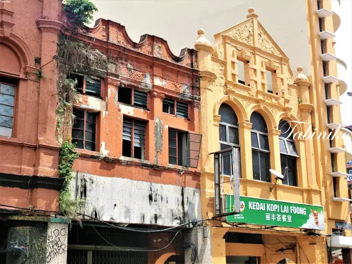 Shophouses in Ipoh featuring Kedai Kopi Lai Foong, showcasing heritage architecture with ornate facades and weathered textures.