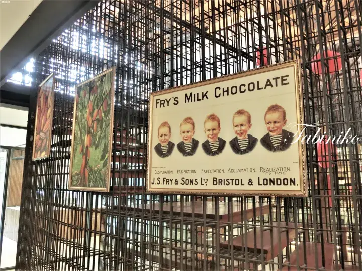 Vintage Fry’s Milk Chocolate sign with five children displayed on a metal grid wall.