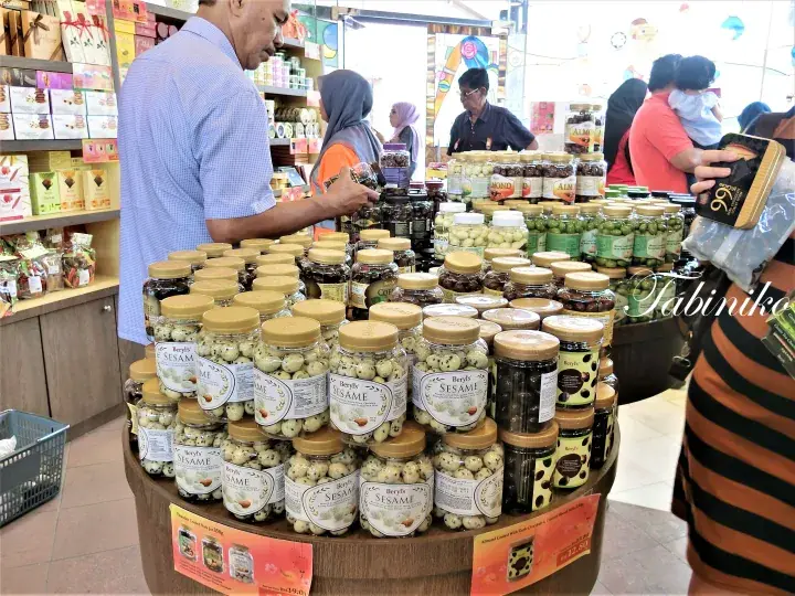 A customer browses jars of Beryl’s Sesame treats at a retail display in a Malaysian shop.