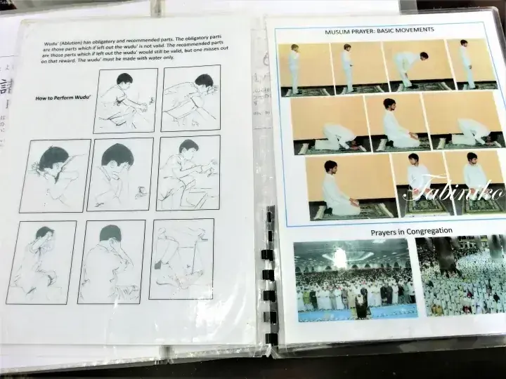 Open booklet showing illustrated steps for performing Wudu and basic Muslim prayer movements alongside photos of congregational prayers.