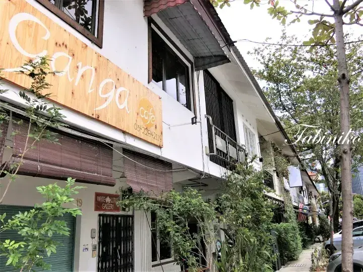 Ganga Cafe exterior with wooden signage and lush greenery in a Malaysian neighborhood setting