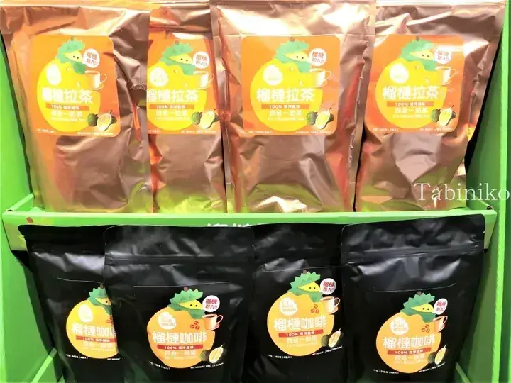 Shelves displaying Durian BB 4-in-1 Durian Milk Tea and Durian Coffee sachets in orange and black packaging.