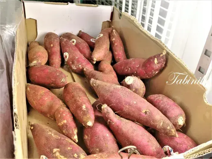 Fresh sweet potatoes in a cardboard box, showcasing local Malaysian produce.