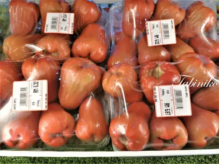 Fresh water apples packaged in clear plastic with price labels showing RM 6.32 to RM 6.87 at a Malaysian grocery store.