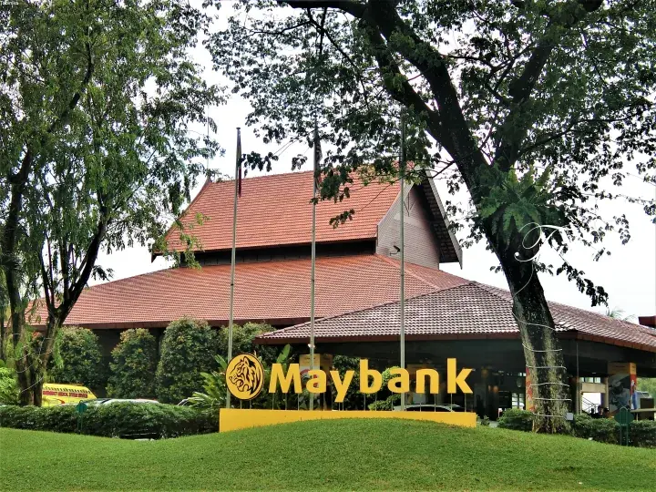 Maybank building with traditional Malay architecture and lush green surroundings