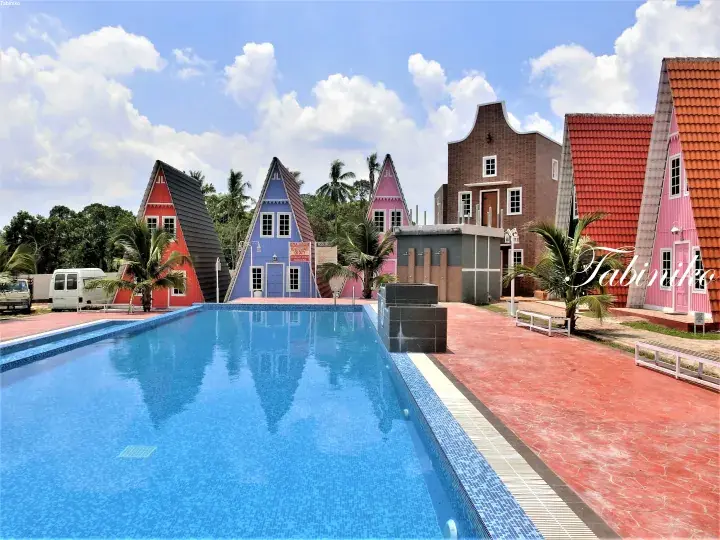Colorful A-frame cabins and a swimming pool at Tabin Eco Resort in Lahad Datu, Sabah.
